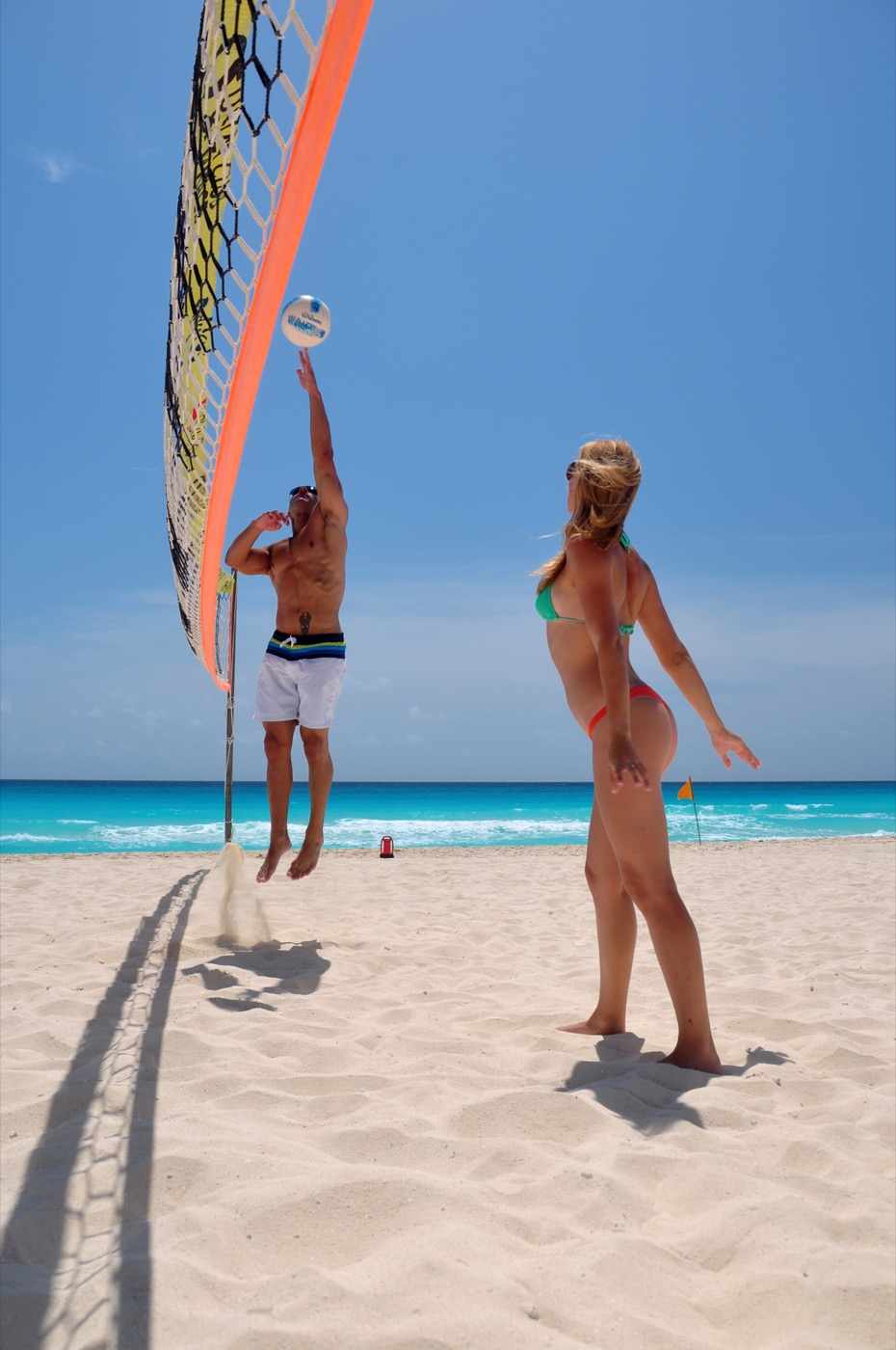 Guests doing activities with entertainers on the beach at Hotel Grand Oasis Cancun