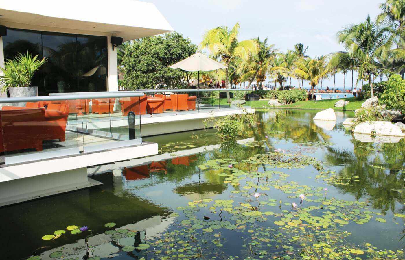 Terrace with armchairs by the lake in hotel The Pyramid at Grand Oasis